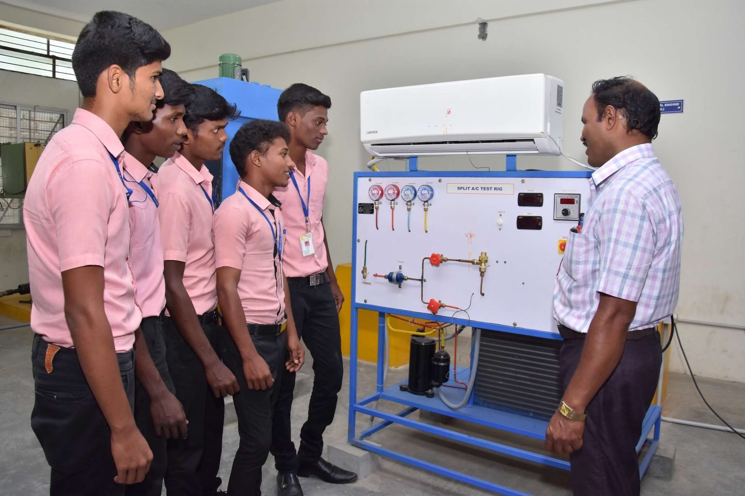 Students at a split air-conditioner test rig