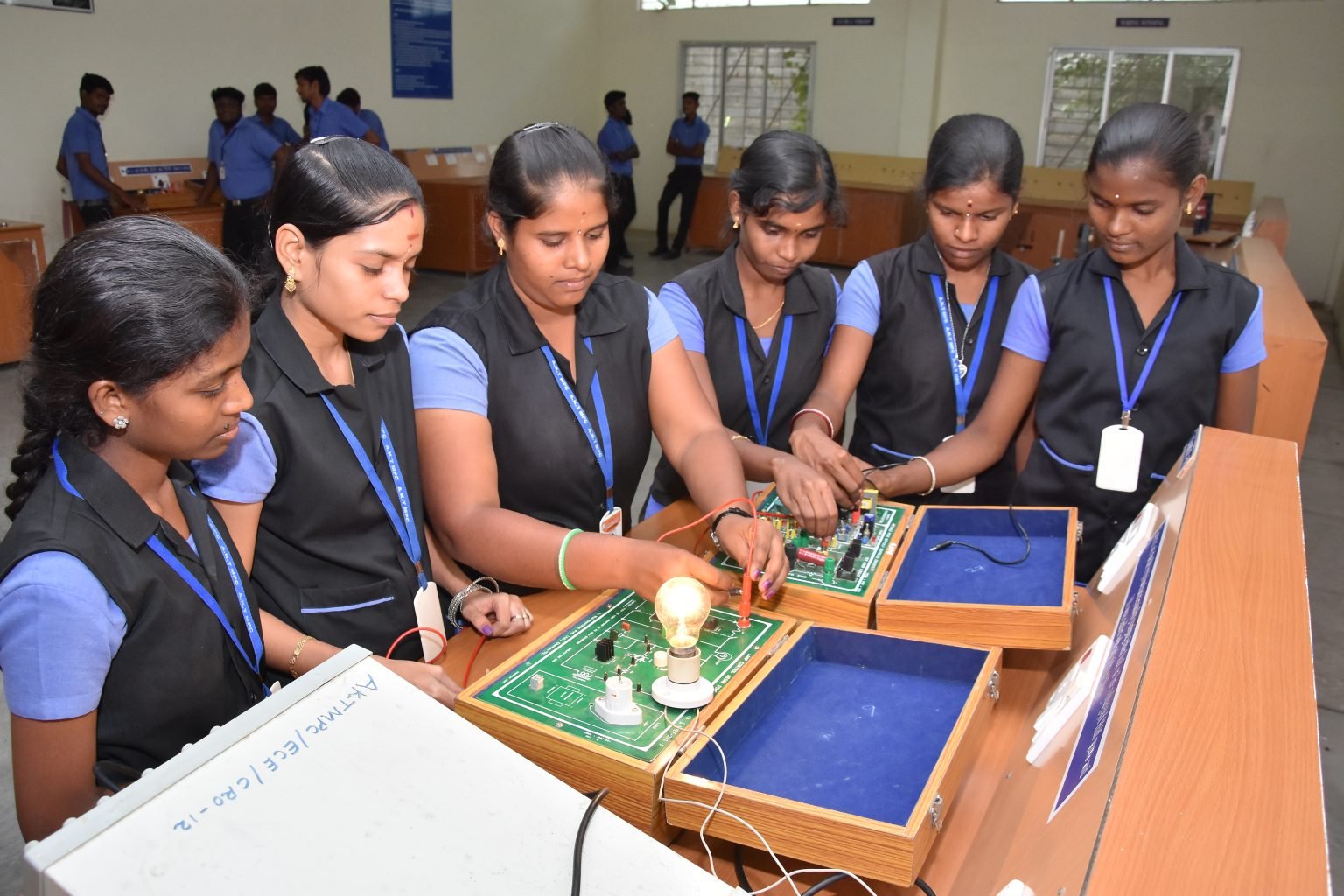 Students using electronics trainer kits