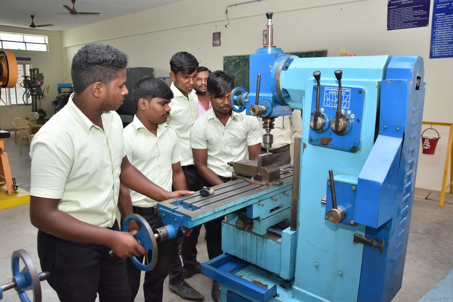 Tool and die students at a milling machine